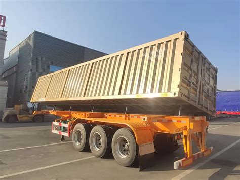 Thematic photo of a two-axle tipper trailer being unloaded on a construction site