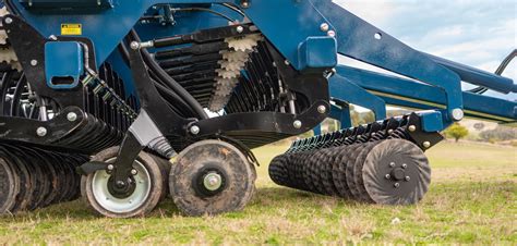 Close-up photo of seed drill coulters precisely placing seeds in the soil