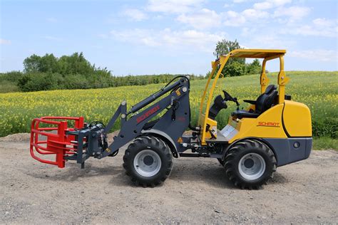 Schematyczna ilustracja ładowarki kołowej HERACLES LGE06 z zaznaczonymi kluczowymi wymiarami i elementami