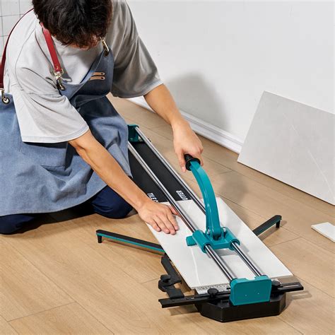 Thematic photo of a person cutting a tile with a tile cutter