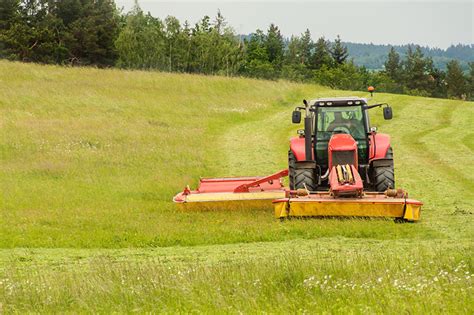 Thematic photo of a garden tractor mowing a lawn in a scenic Polish landscape