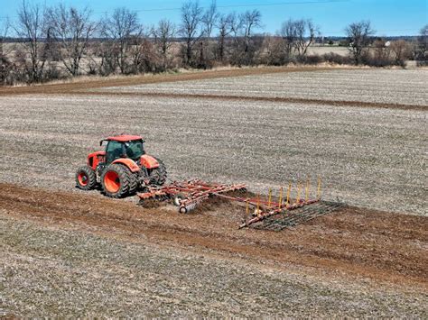 Thematic photo of a tractor pulling a cultivator-seeder in a field