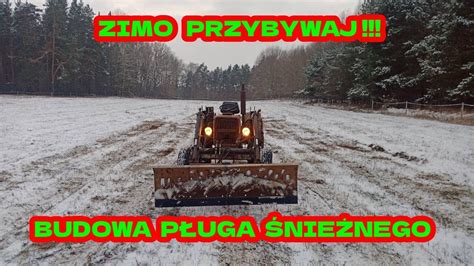 Zbliżenie na detale pługa śnieżnego, pokazujące kształt lemiesza, kabiny i mechanizmów.