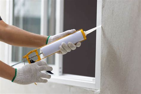 Thematic photo of a window being sealed with silicone, showing a professional application.