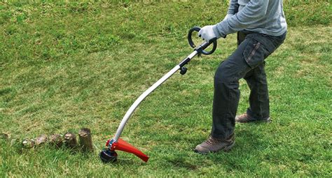 Thematic photo of a person using a Gardena line trimmer in a garden