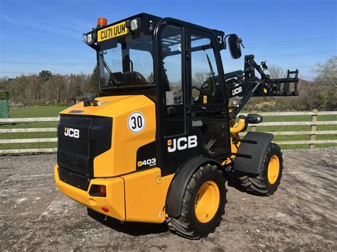 Structural elements of a JCB 403 loader, highlighting arm and chassis