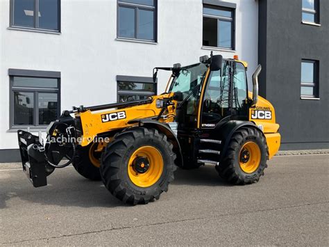 Thematic photo of a JCB TM 320S Agri loader working in a field or agricultural setting.