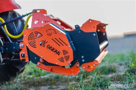 The Orkan logo on an orange flail mower