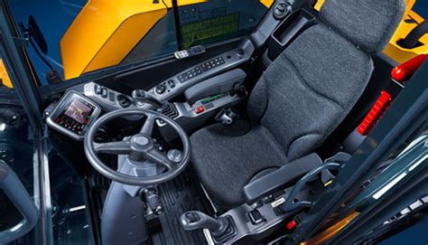 Interior of a modern JCB wheeled excavator cabin with climate control