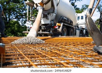 Thematic photo of a construction site with concrete pouring and vibration equipment