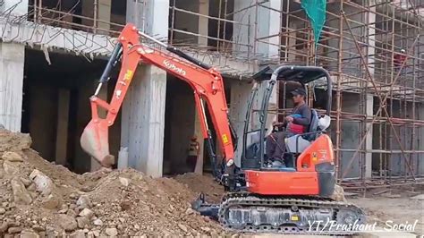 Thematic photo of a Kubota mini-excavator working on a construction site