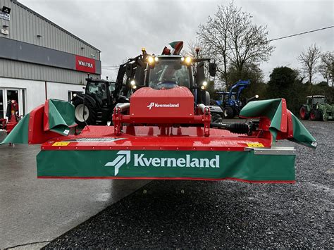 Photo of a Kverneland Taarup front-mounted disc mower (e.g., 3632 FT) in action