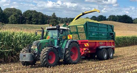 Thematic photo of a BSS Brandys dump trailer working in a field, possibly transporting grain or silage