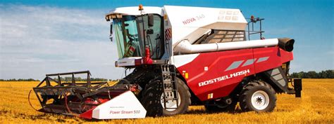 The Rostselmash NOVA combine harvester working in a small field, showcasing its compact size and maneuverability. Include a focus on its modern design.
