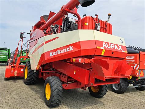 Aupax GV100 or GM100 combine harvester, focusing on its affordability and compact design.