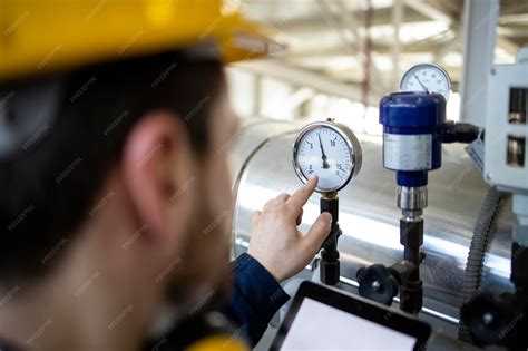 Photo of a diagnostician checking the manometer on a sprayer