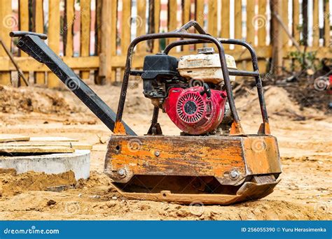Thematic photo of a gasoline plate compactor on a construction site