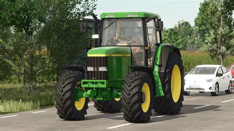 Thematic photo of a John Deere 6010 series tractor working in a field