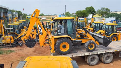 Photo showing a new JCB excavator parked in front of a dealership