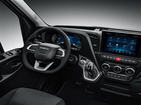 Photo of the interior/dashboard of an Iveco Daily showing key features like HI-MATIC shifter, infotainment, and controls
