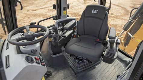 Interior view of the New Holland D-series backhoe loader cabin, highlighting the spaciousness and ergonomic controls.
