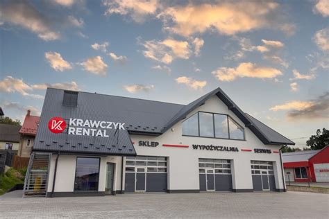 Zdjęcie przedstawiające fasadę wypożyczalni Krawczyk Rental lub ich logo