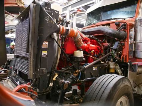 Technical diagram or infographic showing key specifications of a commercial truck engine (e.g., displacement, power, torque)