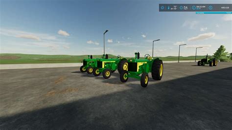 Zdjęcie starszej koparko-ładowarki John Deere z lat 80. lub 90. w trakcie pracy