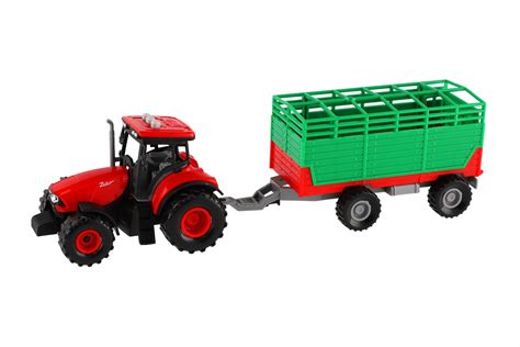 Zabawkowy traktor z włączonymi światłami i wydający dźwięki, jadący z rozrzutnikiem