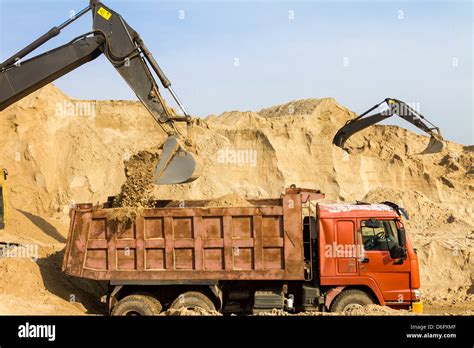 Thematic photo of a construction site with a dumper truck and a mini excavator