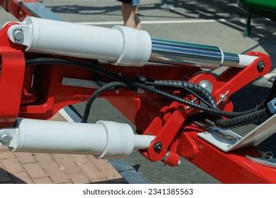 Thematic photo of agricultural machinery with a focus on hydraulic cylinders