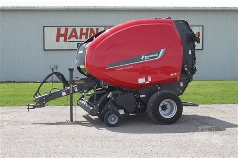 The Kverneland 6716 Plus FlexiWrap in action, baling and wrapping hay in a field