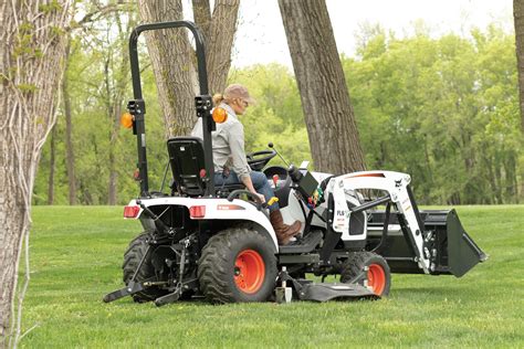 Schematic or infographic illustrating a Kubota mini tractor working in an orchard or vegetable garden.