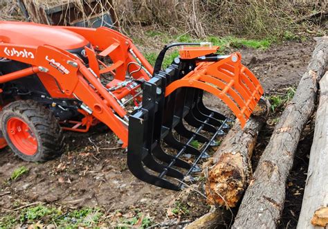 Photo of a Kubota mini tractor with forestry attachments like a winch or grapple.
