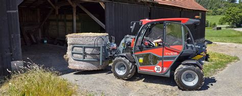 Photo of Weidemann T4512 working at a horse stable, e.g., moving hay bales