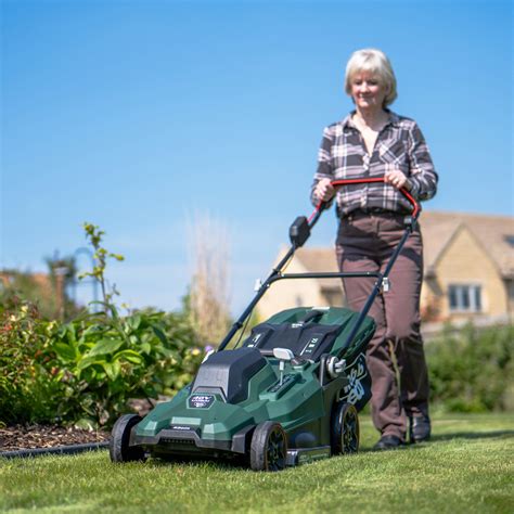 Thematic photo of a person easily operating a cordless lawnmower in a quiet garden setting, emphasizing freedom from cables.