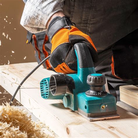 Thematic photo of an electric planer in use, smoothing a wooden surface