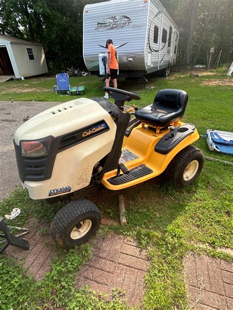 Thematic photo of a well-maintained lawn with a Cub Cadet lawnmower in the background