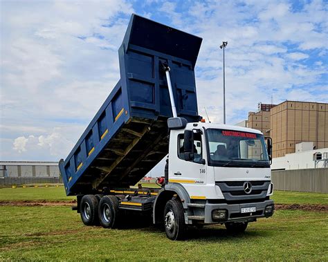 Thematic photo of a C+E truck with a tipper trailer on a construction site or near an asphalt plant