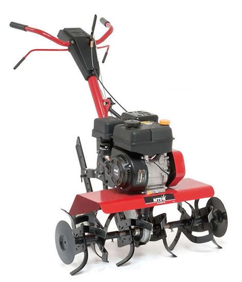 The MTD T/380 M tiller working in a garden bed