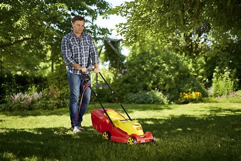 Thematic photo of an electric lawnmower by WOLF-Garten in a garden