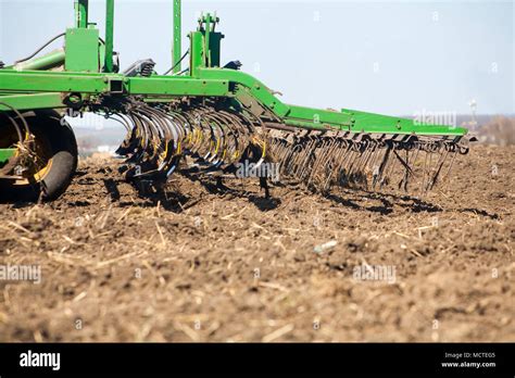 Thematic photo of an agricultural cultivator working in the field
