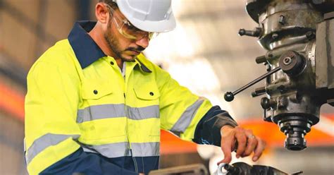 Photo of a technician performing maintenance on a JCB 3CX