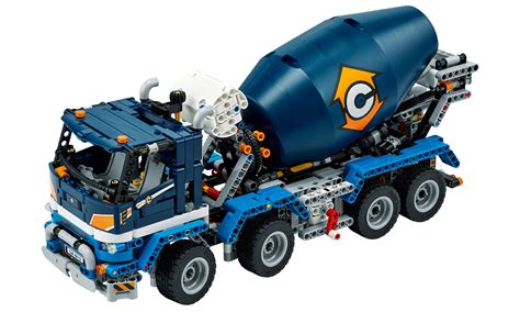 dziecko bawiące się zabawkami takimi jak traktor, betoniarka, klocki LEGO