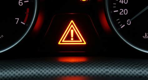 The orange warning triangle with an exclamation mark on a JCB dashboard