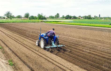 Thematic photo of a modern cultivator on a field, preparing soil for sowing
