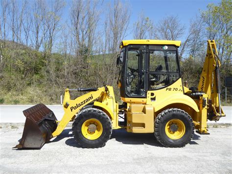 The Palazzani PB 30 P backhoe loader in action, showing both loader and excavator functions.