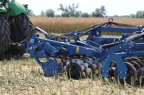 Thematic photo of a knife harrow working in a field during post-harvest cultivation