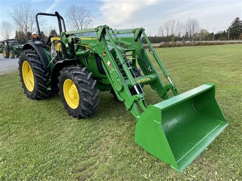 Thematic photo of John Deere 5100M tractor working in the field
