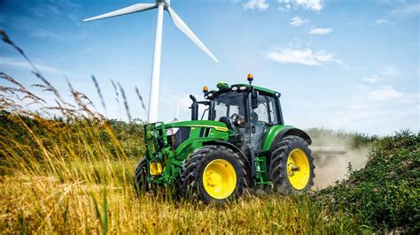 John Deere 6M tractor in action on a field